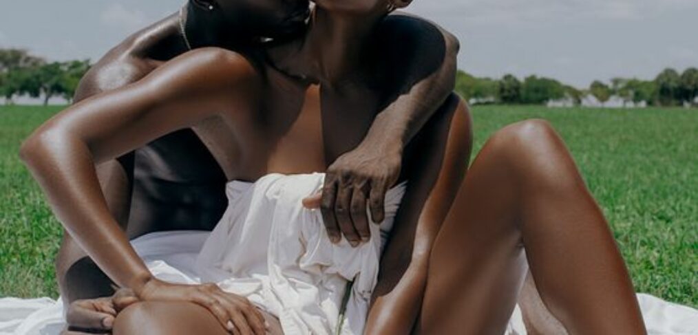 black couples on a semi nude data with flowers