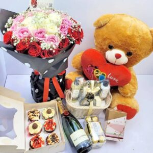Image showing flowers, roses and the following gifts: teddy bear, chocolate, and champagne