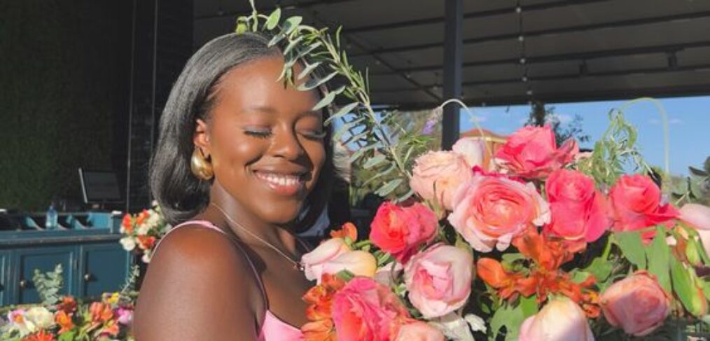 beautiful black woman holding a bouquet of fresh flowers