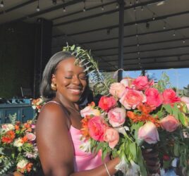 beautiful black woman holding a bouquet of fresh flowers